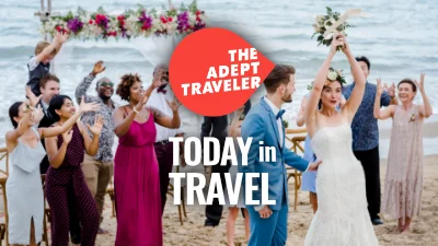 Newlywed bride throwing flowers on a beach during their destination wedding