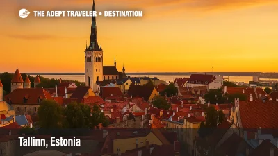 Tallinn Old Town in Estonia at sunset with St. Olaf’s Church spire, medieval towers, and red rooftops glowing under golden skies.