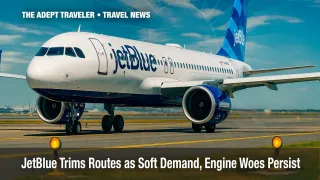 JetBlue Airbus A320neo at JFK under clear sky with foreground taxiway lights.