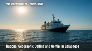 Small National Geographic-branded expedition ship anchored in Galápagos waters during naming ceremony.