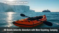 HX Antarctic kayaking and camping program inflatable kayak beside ice cliff.