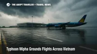 Flooded access road at Hanoi's Noi Bai Airport with Vietnam Airlines jet grounded during Typhoon Wipha travel disruption.