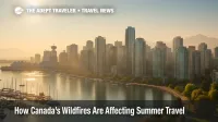 Light wildfire smoke veils Vancouver's harbor skyline, illustrating Canada wildfires travel impact on summer trips.
