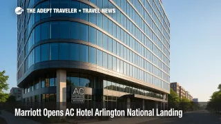 Sun-lit exterior of the new AC Hotel Arlington National Landing near Amazon HQ2, showcasing its curved glass facade and street-level patio, inviting travelers to Washington, D.C.