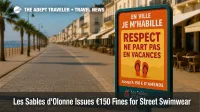Poster on Les Sables d'Olonne promenade warns travelers of €150 swimwear fines, illustrating new dress-code rule.