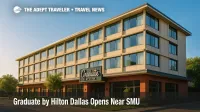Exterior view of Graduate by Hilton Dallas, the brand's first Texas hotel, under a clear morning sky.