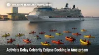 Kayaks blockade Celebrity Eclipse outside Amsterdam Passenger Terminal during Extinction Rebellion cruise protest.