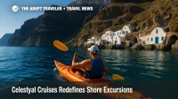 A Celestyal Cruises guest kayaks below Santorini cliffs, showcasing cultural immersion on a boutique cruise shore excursion.