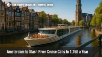 A sleek river-cruise vessel glides past historic canal houses in Amsterdam, illustrating the city's new river cruise cap policy.