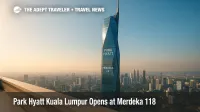 Elevated view of Merdeka 118 with Park Hyatt Kuala Lumpur near the top, blue sky and city skyline framing the new luxury hotel in Malaysia.