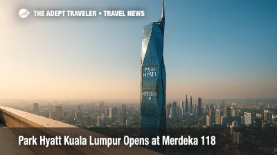 Elevated view of Merdeka 118 with Park Hyatt Kuala Lumpur near the top, blue sky and city skyline framing the new luxury hotel in Malaysia.
