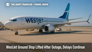 A WestJet 737 sits at a Toronto Pearson gate as operations recover after a system outage and ground stop, with ground crews staging equipment.