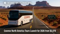 A touring coach approaches Monument Valley's buttes under clear skies, highlighting the value focus of Cosmos North America tours across the Southwest.
