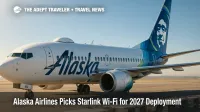 An Alaska Airlines 737 on the ramp as technicians fit a Starlink Wi-Fi radome, highlighting the airline's fast, low-latency inflight Wi-Fi upgrade.