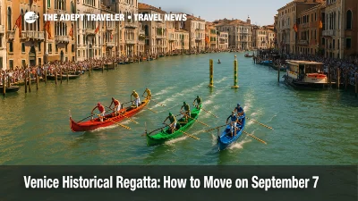 A gondolini race surges up Venice's Grand Canal during the Venice Historical Regatta, with crowds lining the banks and vaporetti held clear.