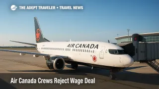 An Air Canada jet at the gate under clear skies as operations continue during a wage dispute focused on pre-flight pay and mediation.