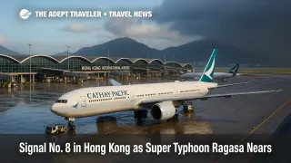 Aircraft stands glisten in rain as Super Typhoon Ragasa curtails operations at Hong Kong International Airport, with ground vehicles paused and low clouds moving in.