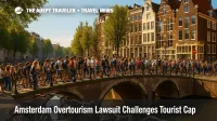 Crowds cross an Amsterdam canal bridge during peak season, illustrating the Amsterdam overtourism lawsuit and the city's tourism cap debate.