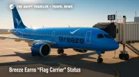 Breeze Airways Airbus A220 at a sunlit gate, highlighting new flag carrier status and Fly America Act eligibility for federal travelers.