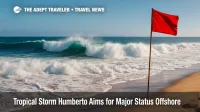 Powerful Atlantic swell and crashing shorebreak illustrate rip-current danger from Tropical Storm Humberto, with a red warning flag visible.