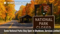 Autumn trees frame a national park entrance road and closed fee station, illustrating national parks shutdown access and suspended fee collection.