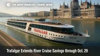 Trafalgar Reverie sails the Danube past Budapest's Parliament, illustrating Trafalgar river cruise savings for 2026 itineraries on the Danube and Rhine.