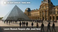 Visitors approach the Louvre glass pyramid amid added security, as the museum reopens after the jewel heist.