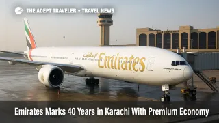 Emirates Boeing 777 at a Karachi gate with Premium Economy showcase signage, marking 40 years of Emirates service to Karachi
