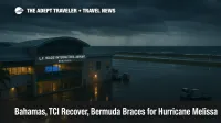 Storm-dark ramp at L.F. Wade International Airport as Hurricane Melissa nears Bermuda, departures board advising travelers to check flight status