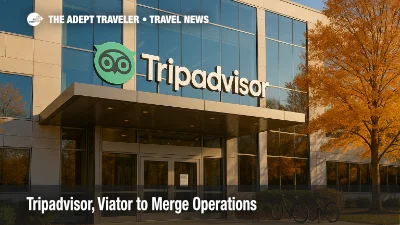 Exterior of Tripadvisor's Needham headquarters with logo signage and autumn campus walkway, illustrating the Tripadvisor and Viator operations merger and traveler impact