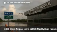 Belém airport entrance with COP30 access control sign and barricades, wet pavement, and control tower visible, warning travelers to expect detours near Parque da Cidade