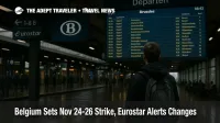Traveler checks the departures board inside Brussels-Midi during the Belgium strike window, Eurostar and SNCB wayfinding visible, concourse lightly crowded