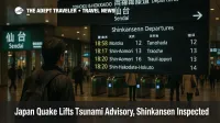 Traveler views the Shinkansen board at JR Sendai Station after Iwate's quake, with small crowds and ticket gates visible during evening inspections
