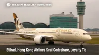 Etihad 787 taxiing at Hong Kong International Airport with terminal and tower visible, illustrating the new codeshare and loyalty partnership