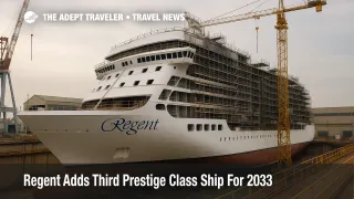 Regent Seven Seas Prestige Class hull taking shape at Fincantieri Marghera, cranes and scaffolding framing the yard during bright overcast