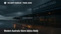 Wet curbside at Broome International Airport with shuttle bay and storm clouds overhead, matching Western Australia storm advice and Broome transfers focus