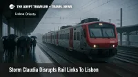 Storm Claudia floods tracks and slows trains at Lisbon Oriente railway station as passengers wait on a wet platform