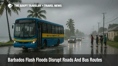Barbados Transport Board bus drives through a flooded coastal road as flash flood warnings disrupt traffic and transfers