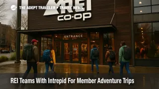 Travelers with packs and luggage outside the REI Seattle flagship store, illustrating the new REI and Intrepid Travel adventure trips partnership