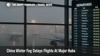 China winter fog flight delays at Beijing Capital airport with jets waiting at foggy gates and departure boards crowded with delayed flights.