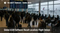 Travelers at JFK watch a departures board as the A320 software recall delays some flights but airport operations continue