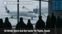 Travelers watch a regional jet being deiced at Des Moines airport as a US winter storm flights disruption ripples toward a Northeast nor'easter