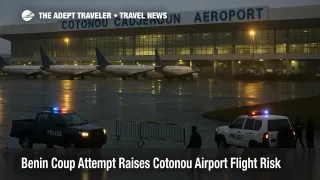 View of Cotonou Cadjehoun Airport during the Benin coup attempt, showing aircraft on the apron, security vehicles at the terminal, and travelers facing potential flight delays.