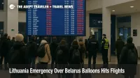 Travelers watch a departures board at Vilnius as Lithuania Belarus balloons flights disruption causes delays during the state of emergency