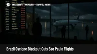 Travelers wait near a departures board at Sao Paulo Guarulhos as a Brazil cyclone blackout disrupts flights and leaves the wet ramp under low storm clouds