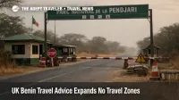 UK Benin Travel Advice shift shown by a quiet Pendjari park gate, signaling reroutes for north Benin safari trips