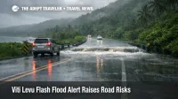 Viti Levu flash flood alert, wet Coral Coast road with water over a low bridge, signaling transfer delays