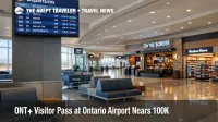 ONT+ visitor pass Ontario Airport shown by an empty post security concourse with gates, shops, and a departures board