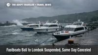 Bali Lombok fastboats suspended as rough seas pound Padang Bai pier, with stranded boats under dark monsoon clouds