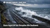 Storm Ingrid UK rail disruption at Dawlish shows waves and debris beside wet tracks, signaling closures and delays